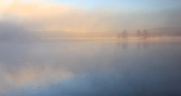 A foggy sunrise on the Yellowstone River. Yellowstone National Park, Wyoming.